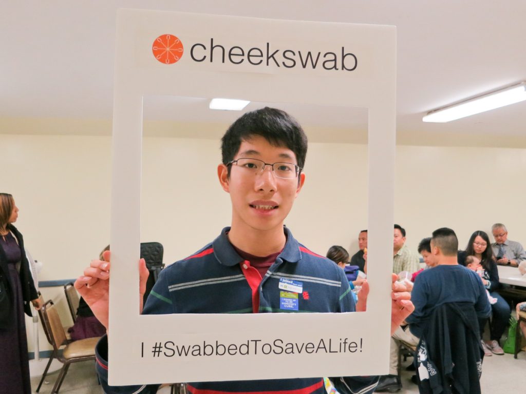 Young Asian man smiling in cheekswab frame