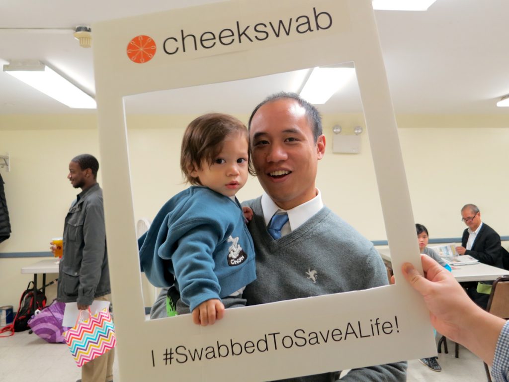 Man and son smiling in Cheekswab frame